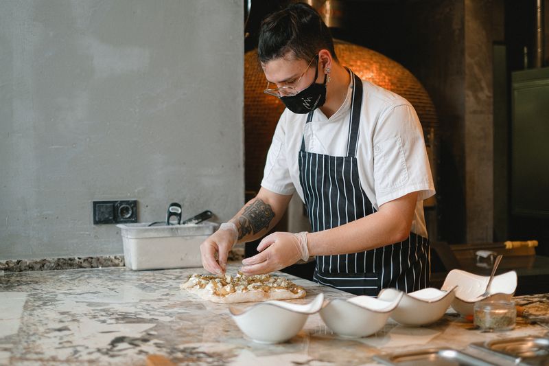Jets pizza team crafting pizzas with fresh ingredients
